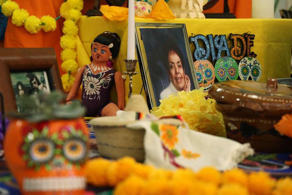 Photos, family mementos and colorful flowers decorate a Day of the Dead altar at the Utah State Capitol.